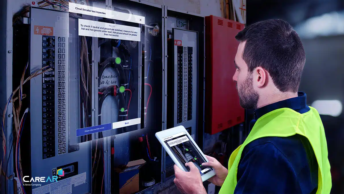 FieldService-Instruct-man-safety-vest-tablet-16×9 field worker solving with CareAR Instruct